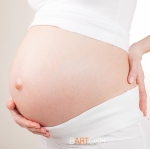 pregnant woman holding her belly arms